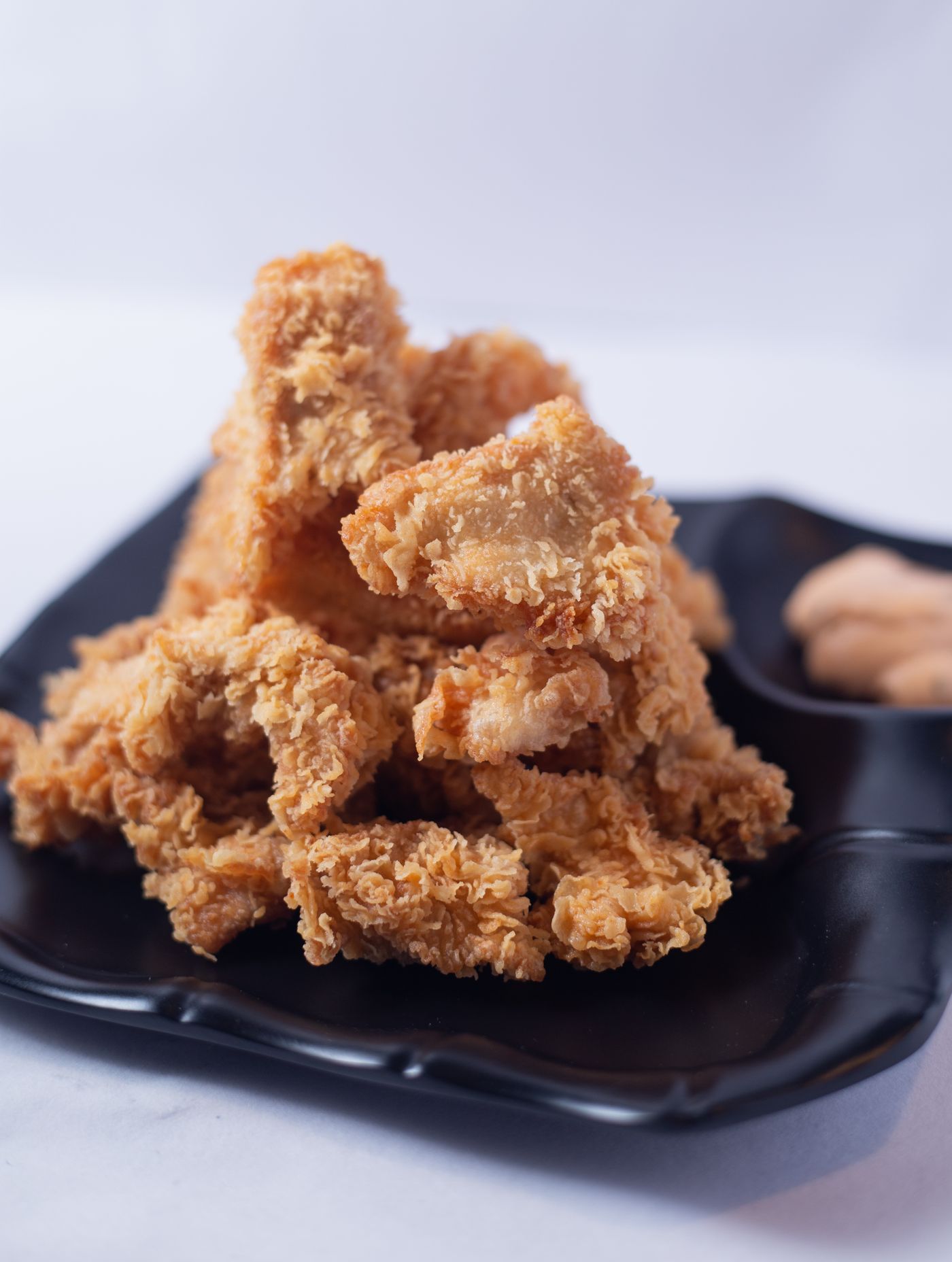 Crispy King Wing fried chicken stacked on a plate